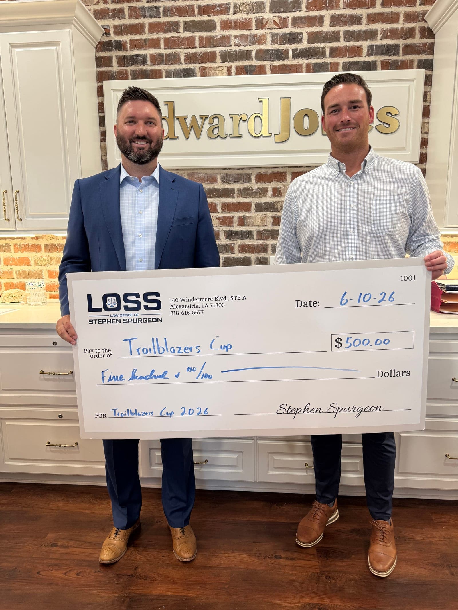 Stephen Spurgeon presenting a check from the firm to the 2026 Trailblazers Cup